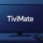Wide digital illustration of a modern flat-screen TV with the word TiviMate displayed on the screen, set on a sleek dark stand with a black remote in front, against a blue gradient background.
